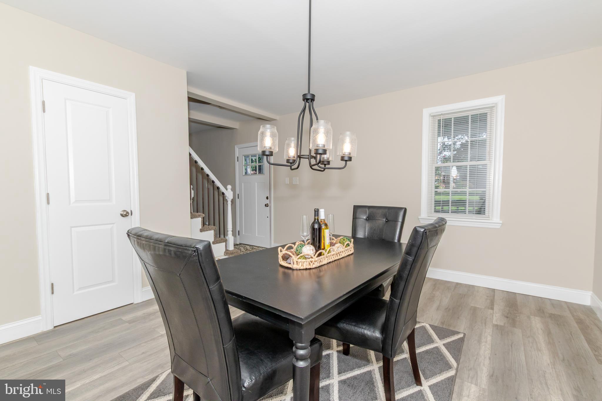 100 North 1st Road Hammonton, NJ 08037 - Photo 14 of 47 a dining room with furniture a chandelier and wooden floor