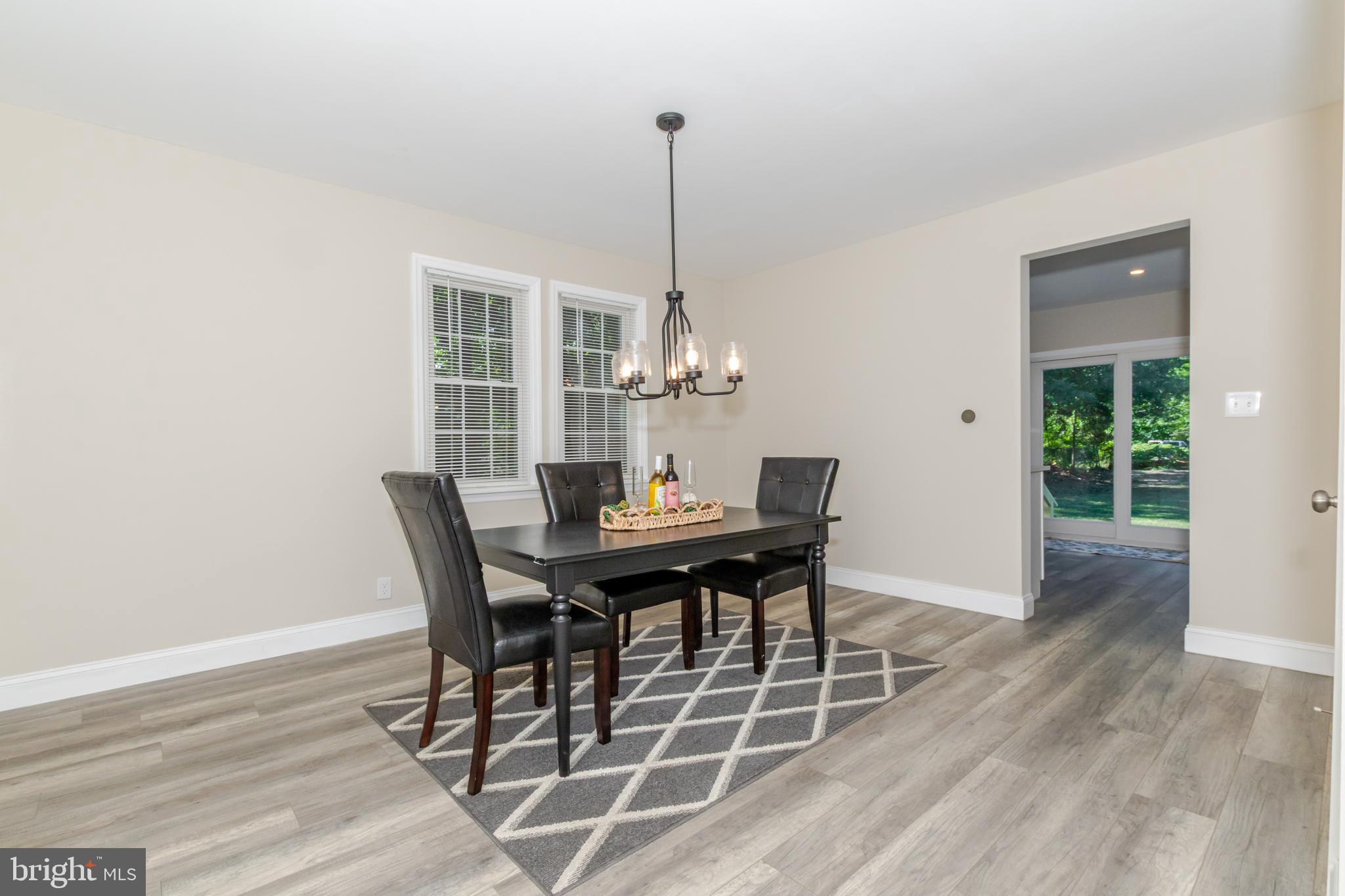 100 North 1st Road Hammonton, NJ 08037 - Photo 17 of 47 a dining room with furniture a chandelier and wooden floor