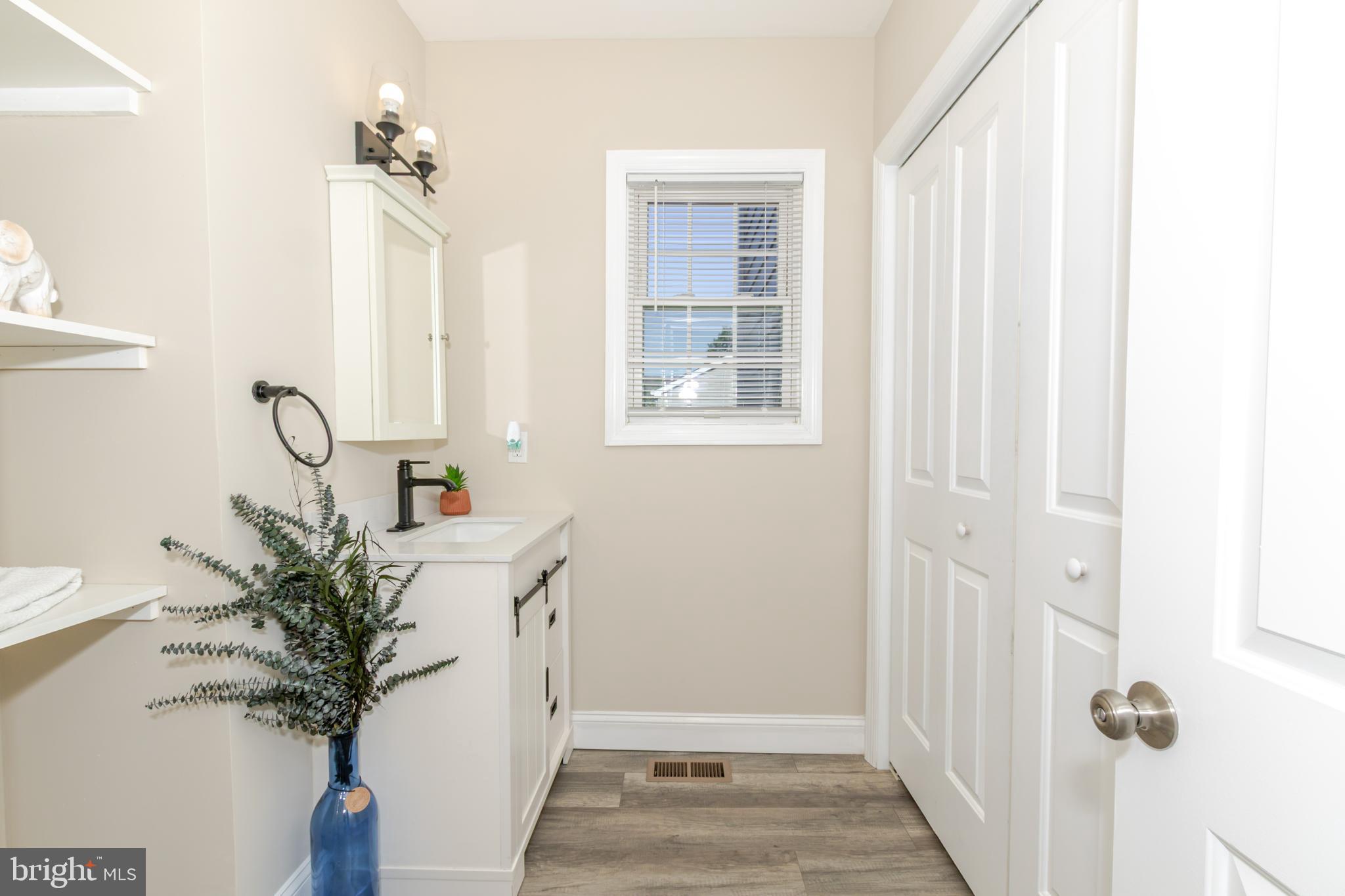 100 North 1st Road Hammonton, NJ 08037 - Photo 19 of 47 a view of a hallway with wooden floor and a potted plant