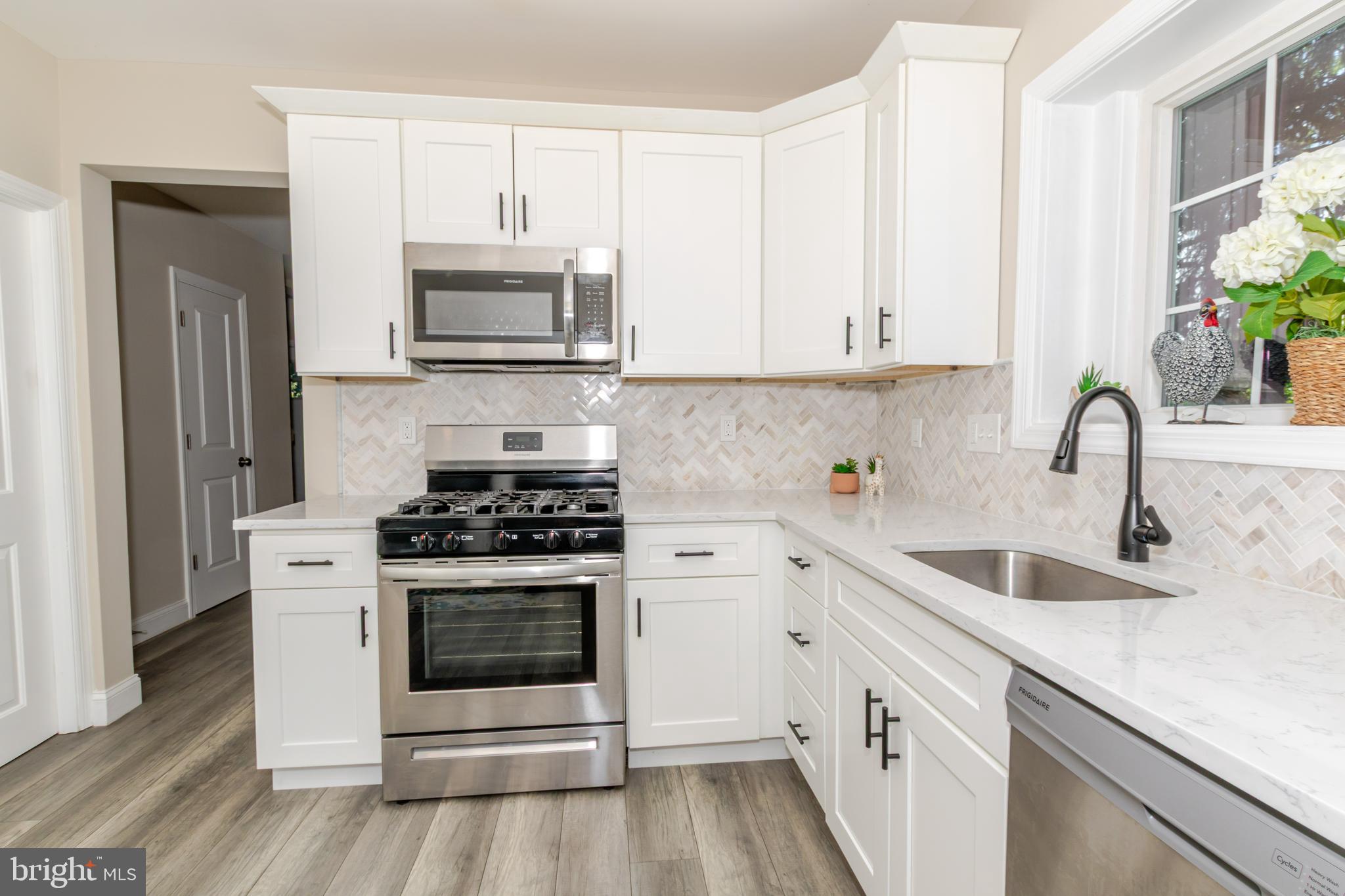 100 North 1st Road Hammonton, NJ 08037 - Photo 6 of 47 a kitchen with white cabinets a sink and stainless steel appliances
