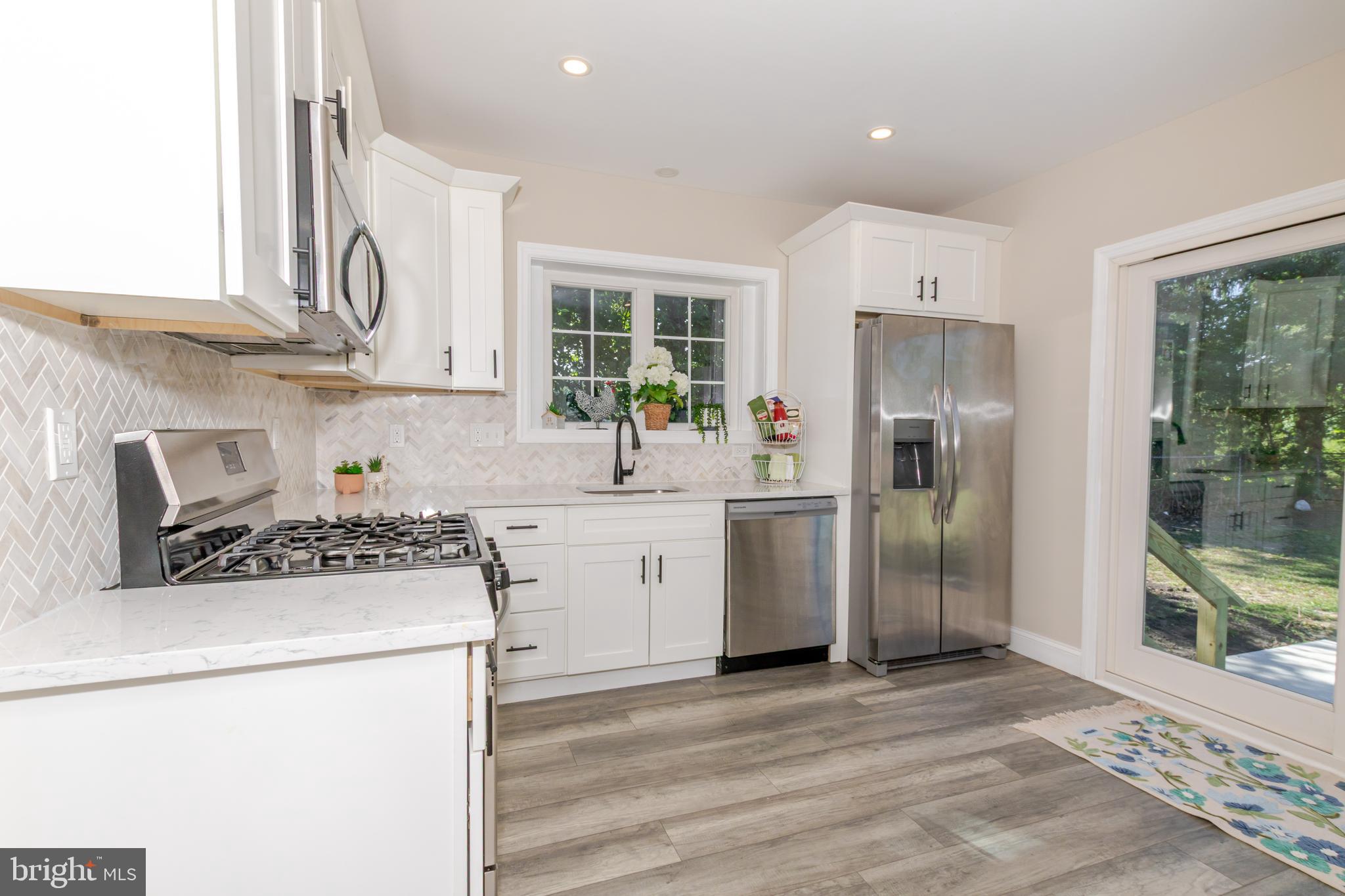 100 North 1st Road Hammonton, NJ 08037 - Photo 7 of 47 a kitchen with a stove a refrigerator and a sink