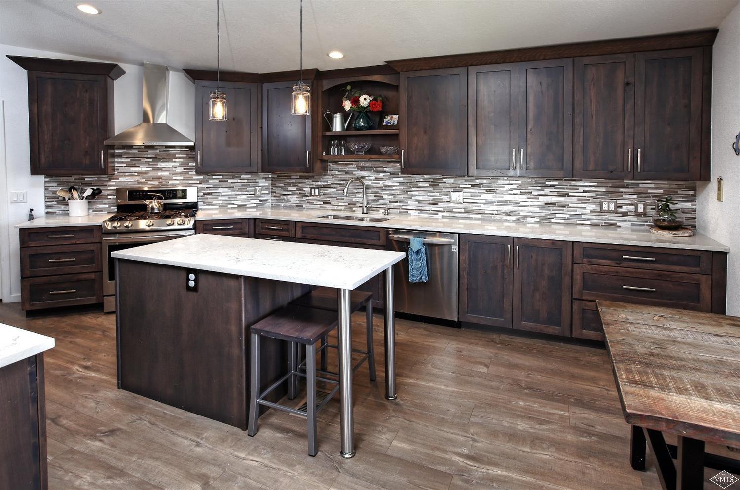 134 Ringneck Eagle, CO 81631 - Photo 9 of 25 a kitchen with stainless steel appliances granite countertop wooden cabinets a sink and a stove