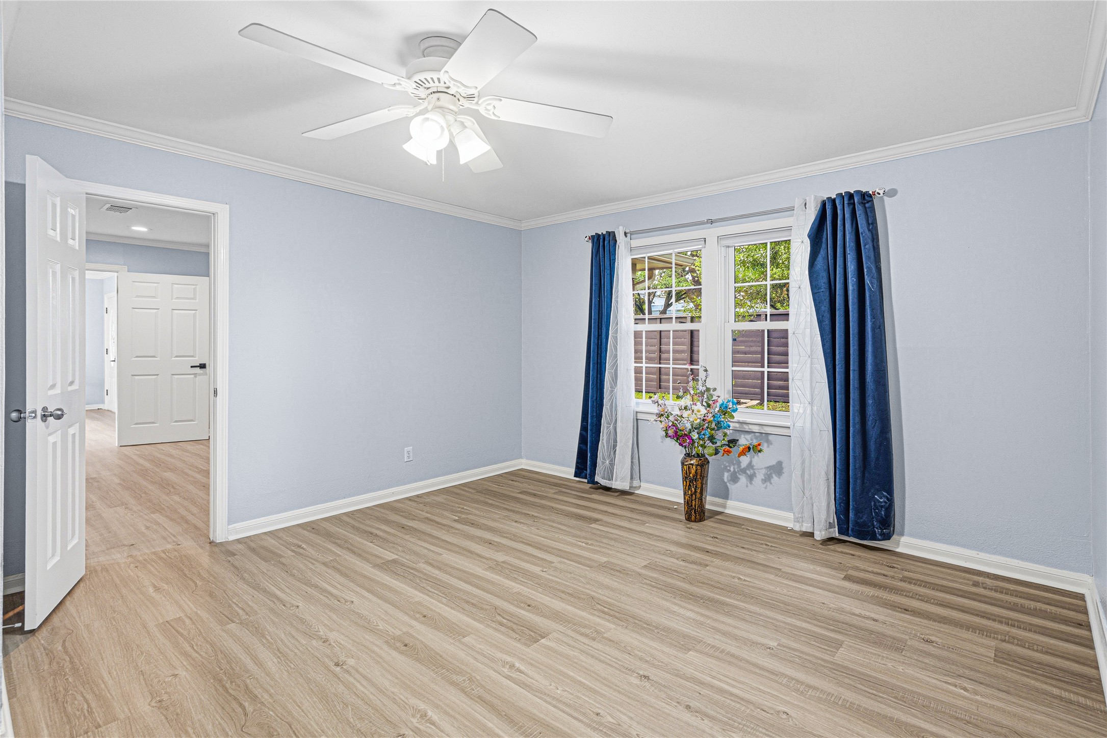 4002 Merrick Street Houston, TX 77025 - Photo 10 of 22 a view of a livingroom with a chandelier fan and windows