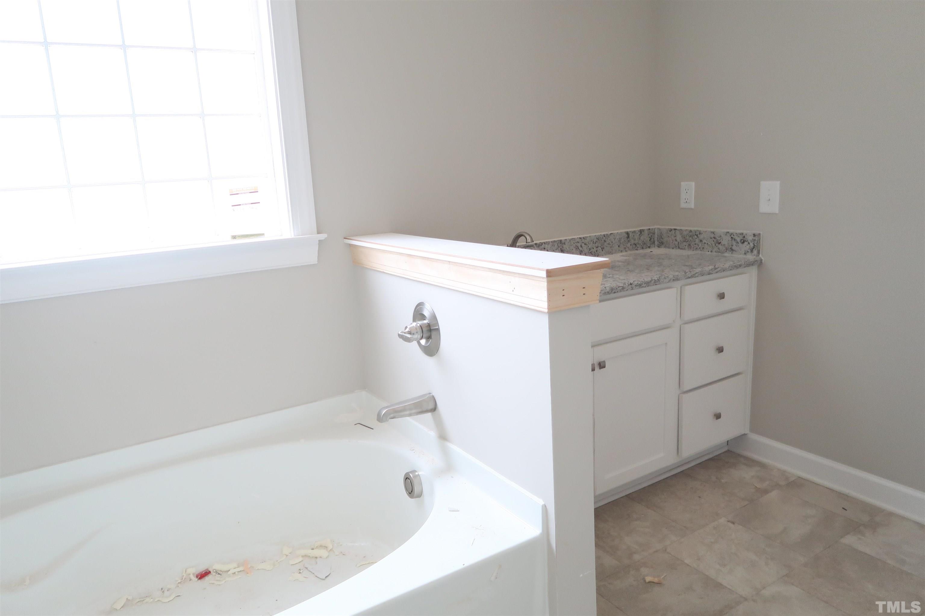 1191 Denning Road Angier, NC 27501 - Photo 13 of 25 a bathroom with a bathtub and a sink