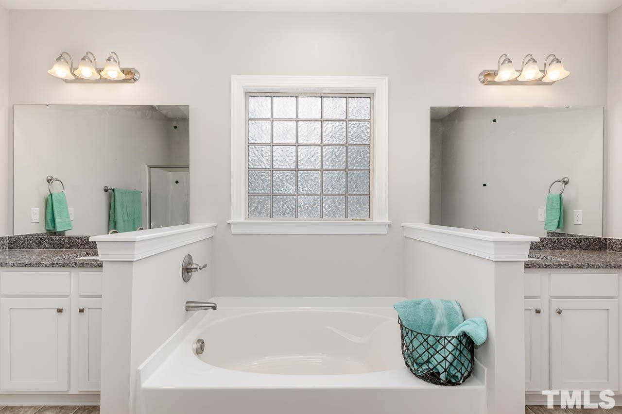 1191 Denning Road Angier, NC 27501 - Photo 22 of 25 a bathroom with a granite countertop sink and a mirror