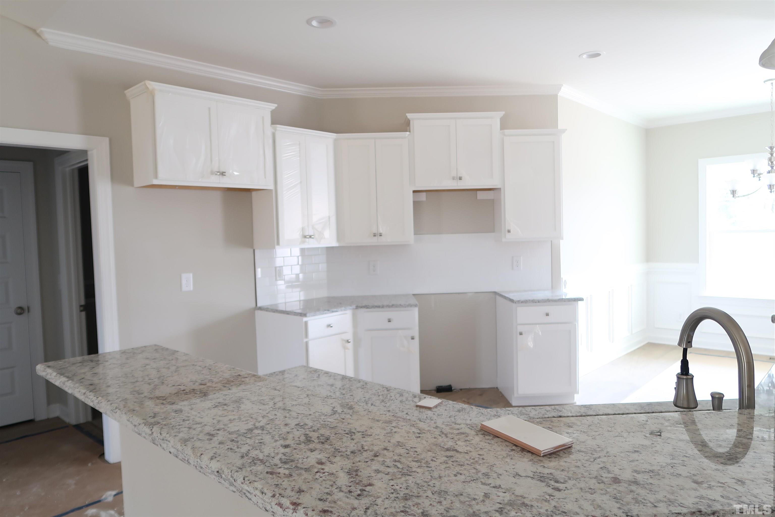 1191 Denning Road Angier, NC 27501 - Photo 7 of 25 a kitchen with a sink cabinets and stove