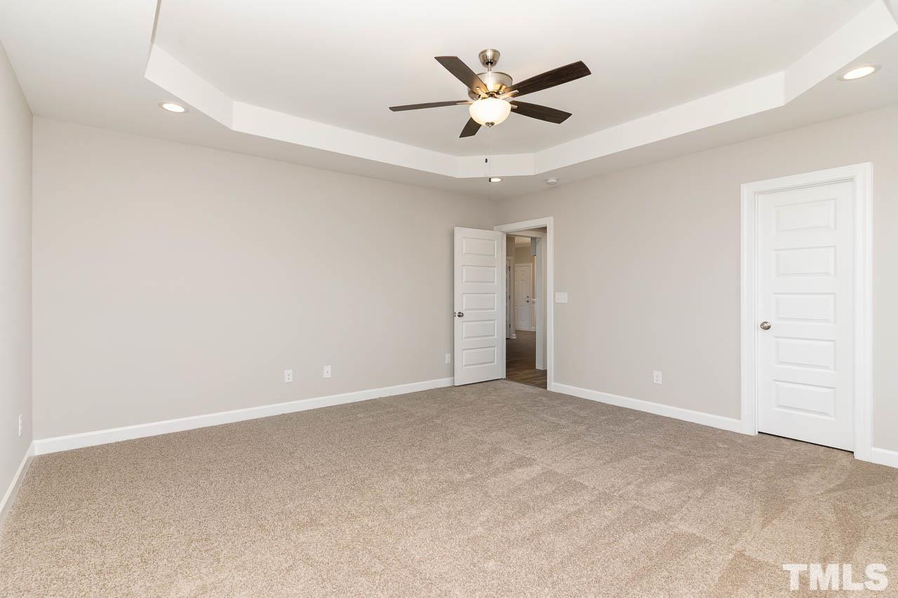 1191 Denning Road Angier, NC 27501 - Photo 10 of 25 an empty room with a ceiling fan and a window