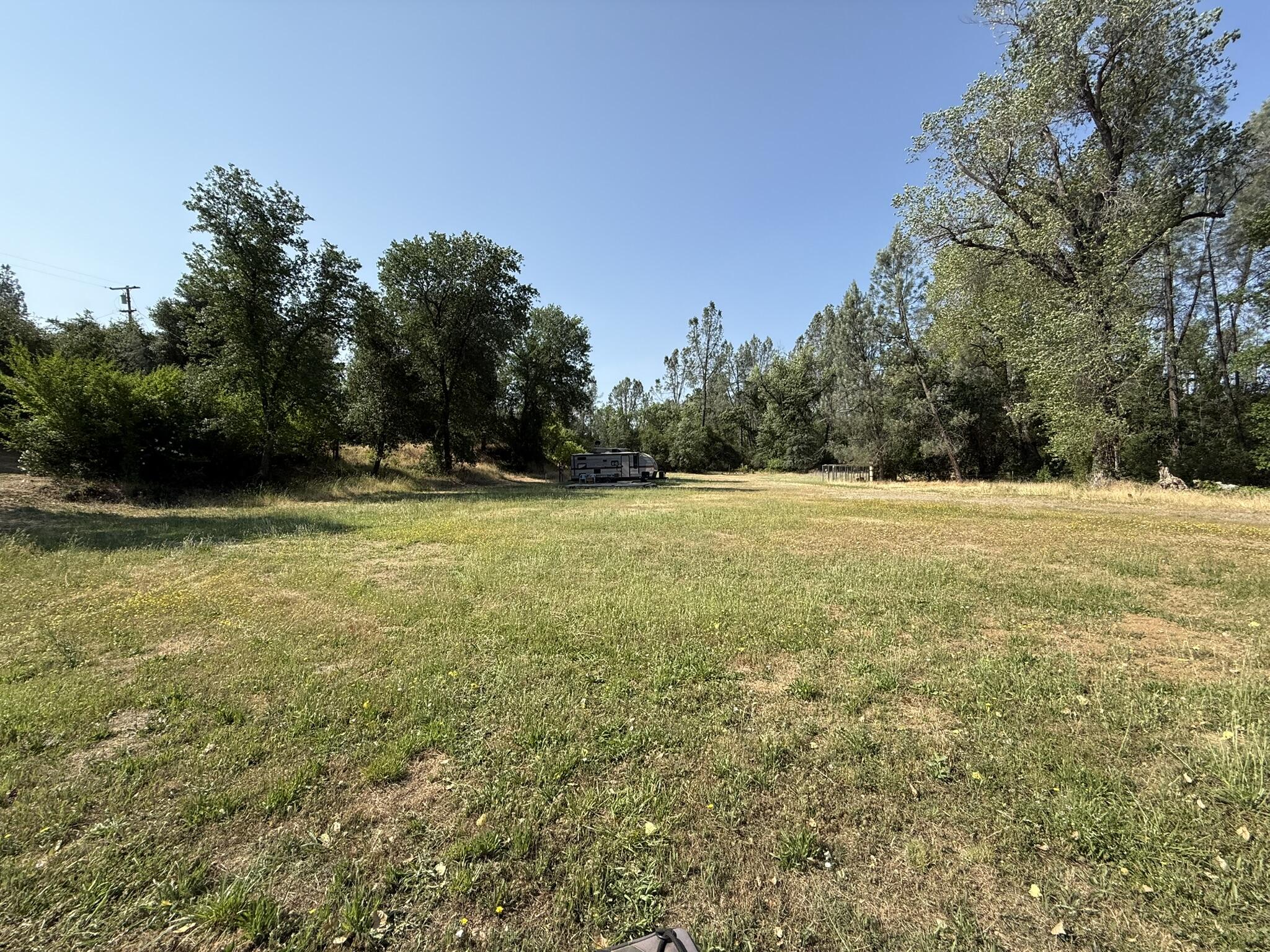 7780 Raven Road Redding, CA 96001 - Photo 4 of 6 a view of outdoor space with swimming pool and trees in the background