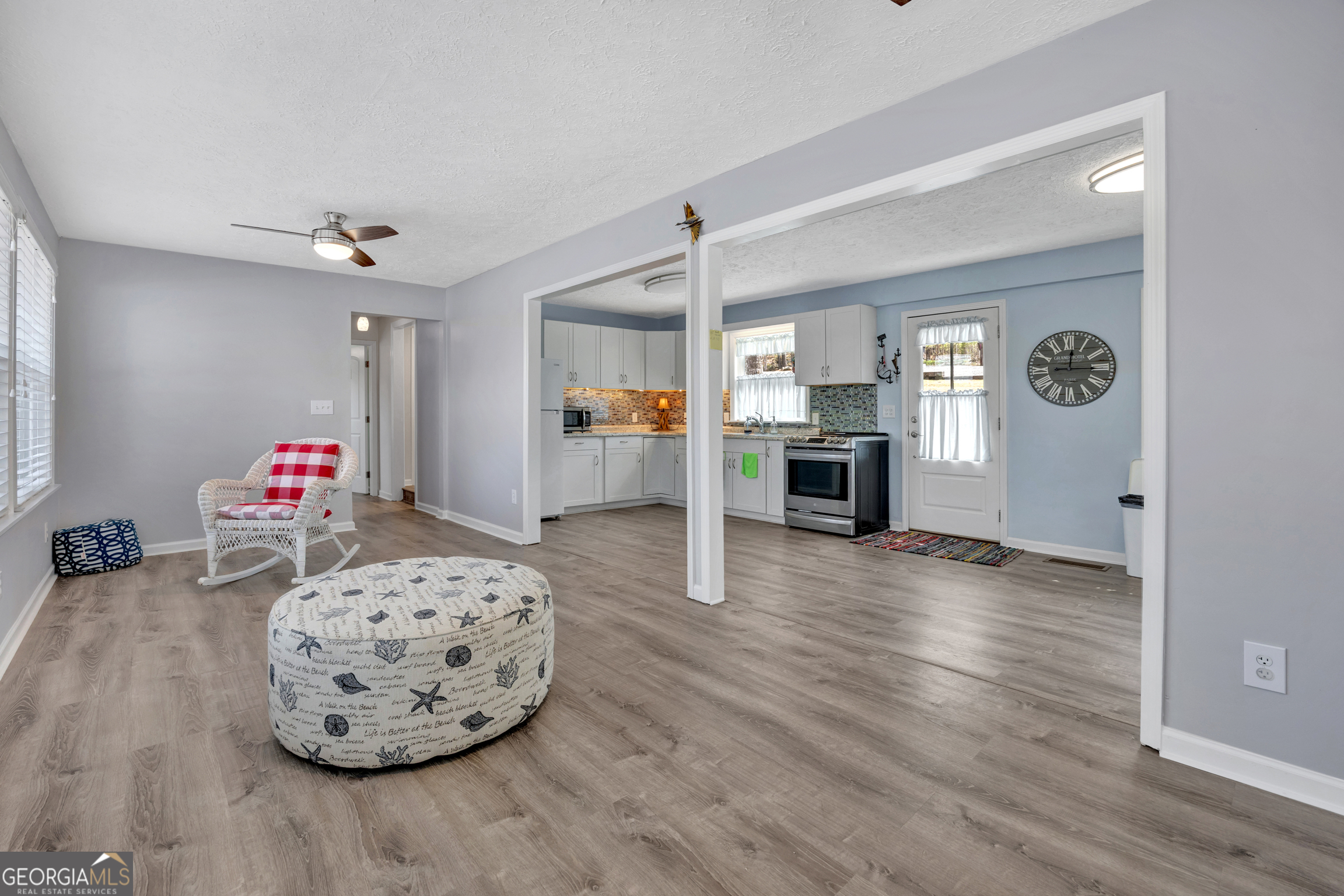 411 Alcovy Road Mansfield, GA 30055 - Photo 14 of 49 a living room with furniture and a wooden floor