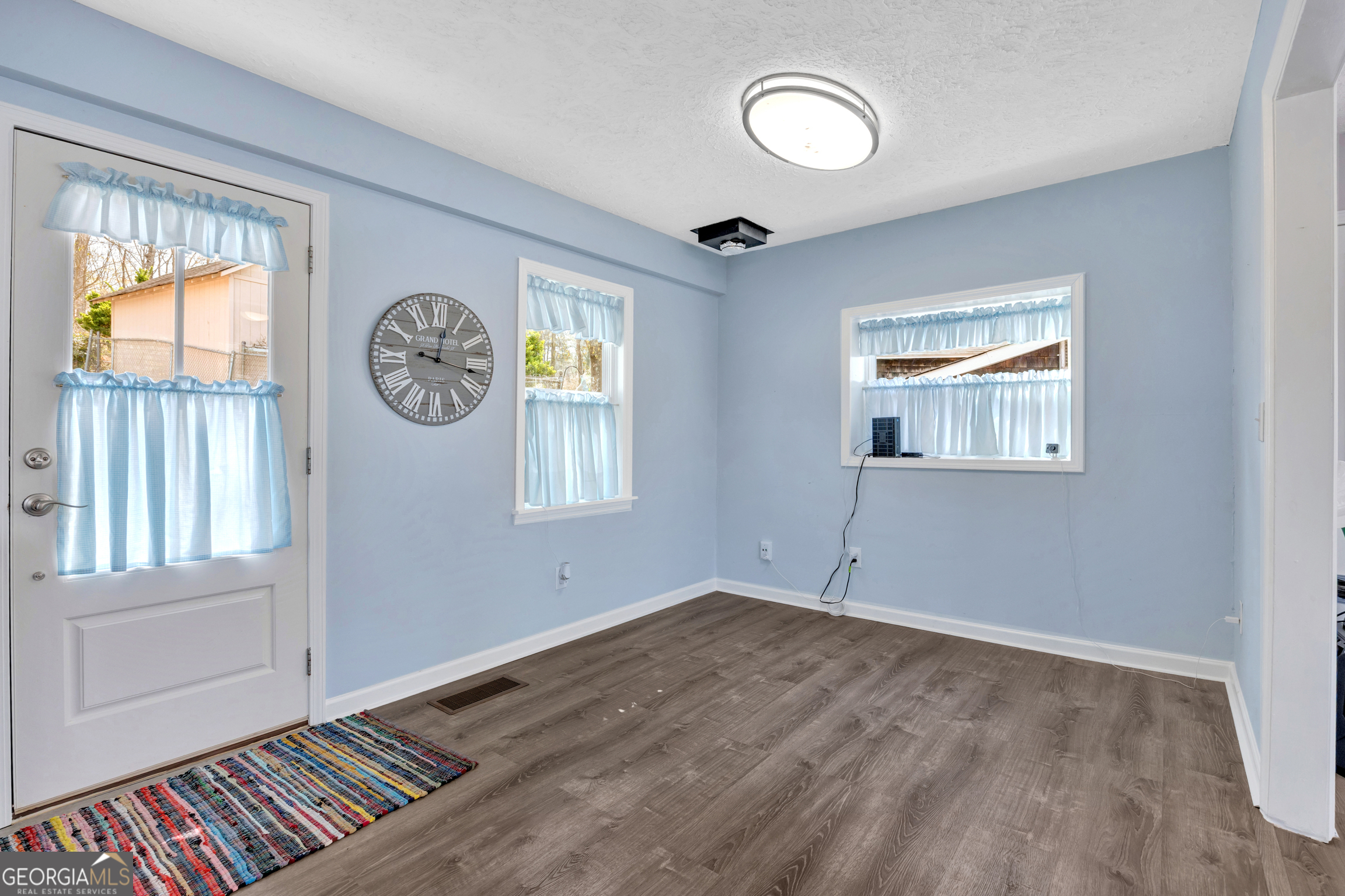 411 Alcovy Road Mansfield, GA 30055 - Photo 19 of 49 a view of an empty room with window and wooden floor