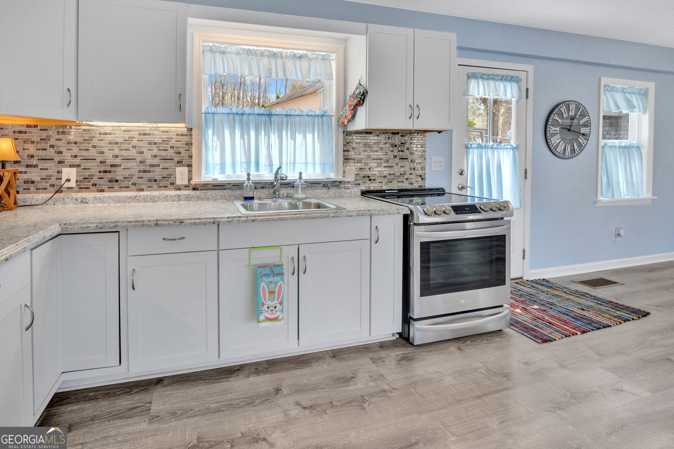 411 Alcovy Road Mansfield, GA 30055 - Photo 21 of 49 a kitchen with a stove and a sink