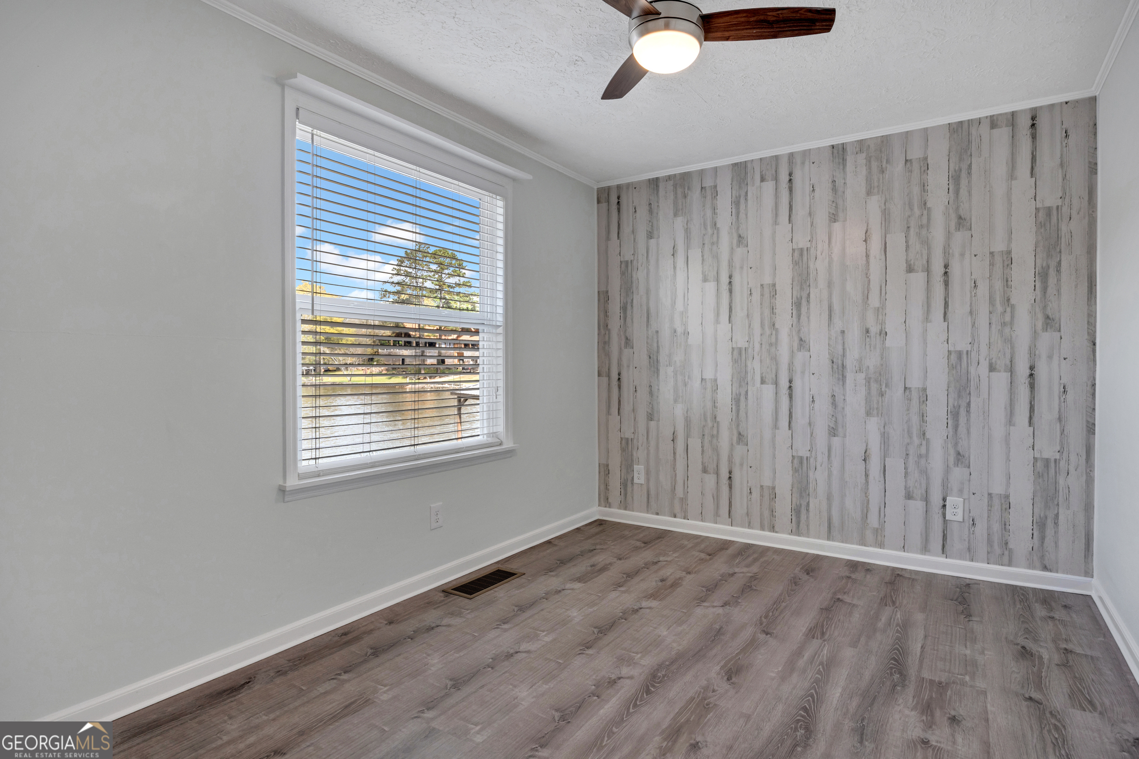411 Alcovy Road Mansfield, GA 30055 - Photo 25 of 49 a view of an empty room with wooden floor and a window