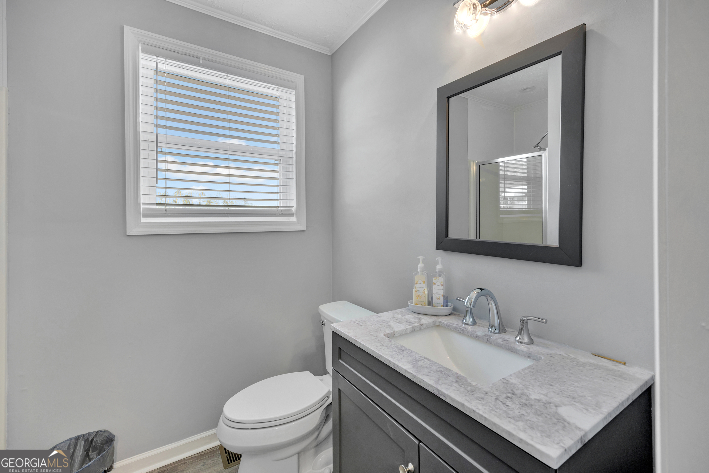 411 Alcovy Road Mansfield, GA 30055 - Photo 27 of 49 a bathroom with a granite countertop sink toilet and mirror