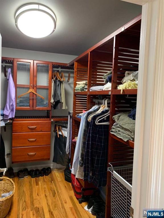 116 Prospect Street Paramus, NJ 07652 - Photo 11 of 17 a view of walk in closet with clothes and shoes