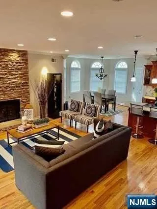 a view of a kitchen with kitchen island granite countertop a sink and a stove