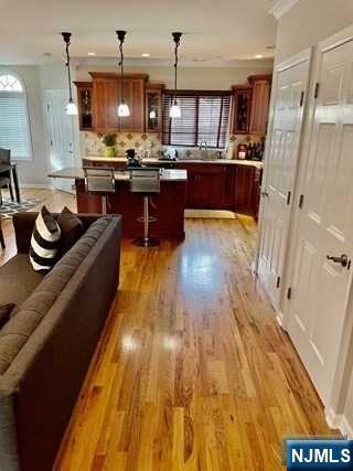 116 Prospect Street Paramus, NJ 07652 - Photo 6 of 17 a kitchen with kitchen island granite countertop wooden floors and stainless steel appliances