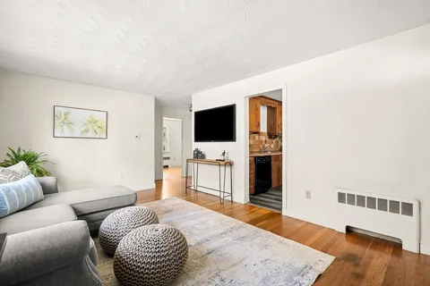 a bedroom with furniture and a flat screen tv