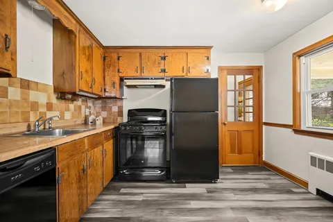 a kitchen with stainless steel appliances granite countertop a refrigerator and a sink