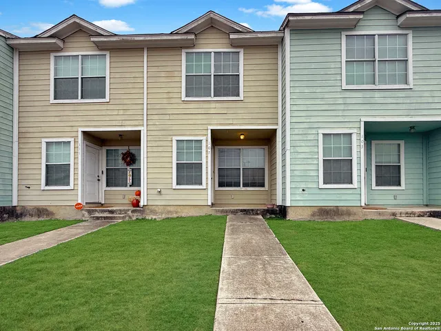 a front view of a house with a yard and front view of a house