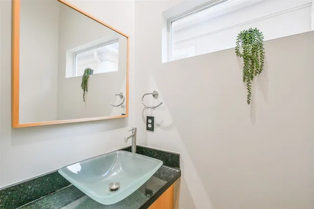 a bathroom with a sink a mirror and vanity