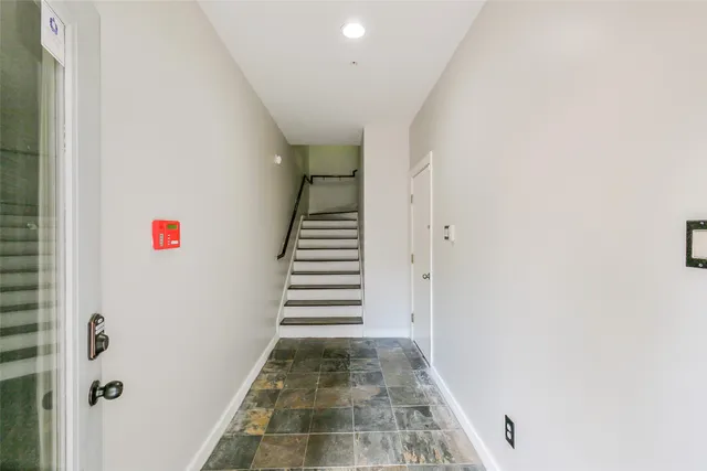 a view of a hallway with stairs