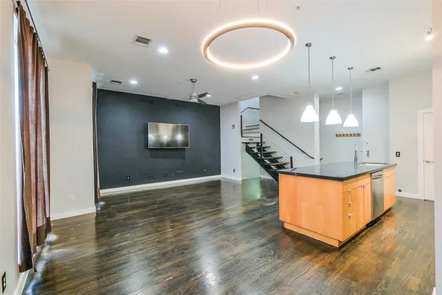 a view of an entryway wooden floor and a chandelier