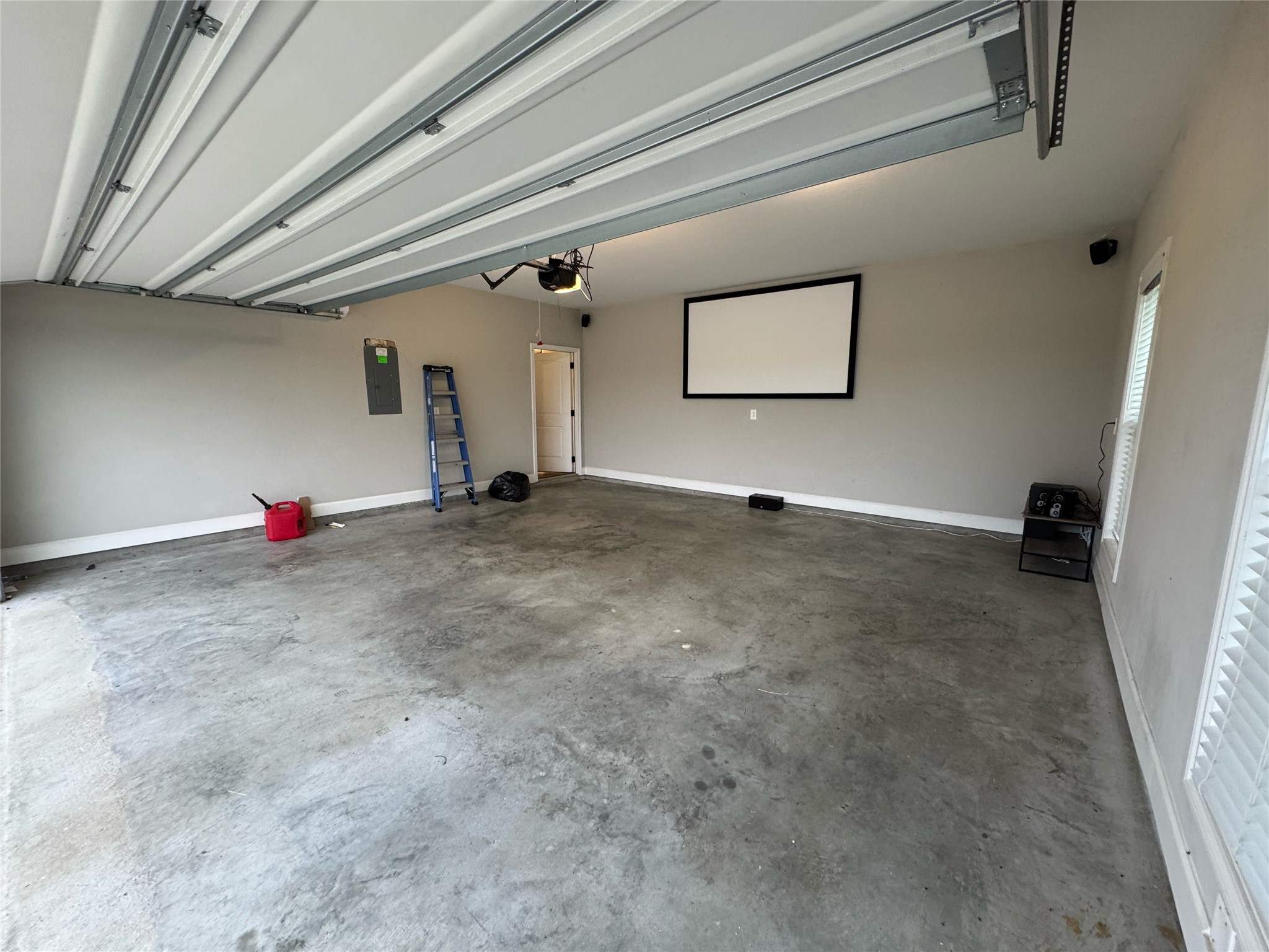 723 Sandy Corner Road El Campo, TX 77437 - Photo 19 of 20 Enjoy a fun family night in your air conditioned garage watching movies.