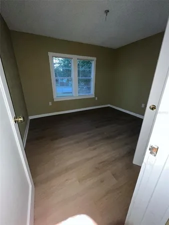 an empty room with wooden floor