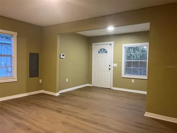 a kitchen with kitchen island granite countertop a sink and cabinets