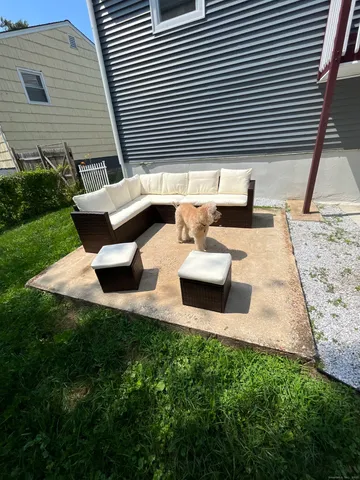 a view of backyard of a house with outdoor seating