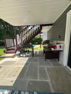 a backyard of a house with table and chairs