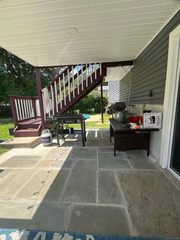 a backyard of a house with table and chairs