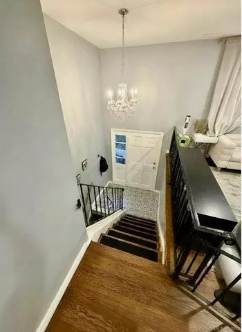 a view of a livingroom with furniture and staircase