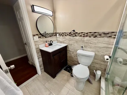 a bathroom with a toilet sink and mirror
