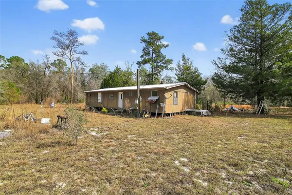 a view of a chairs and table in the backyard