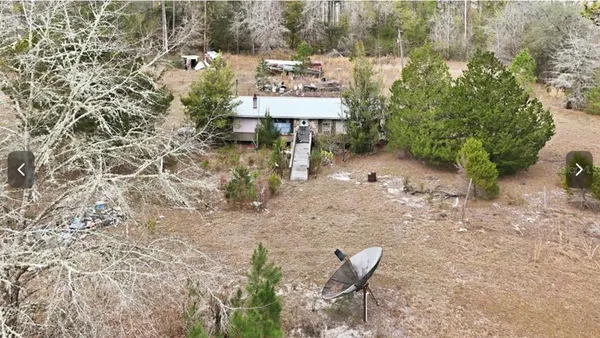 a backyard of a house with table and chairs