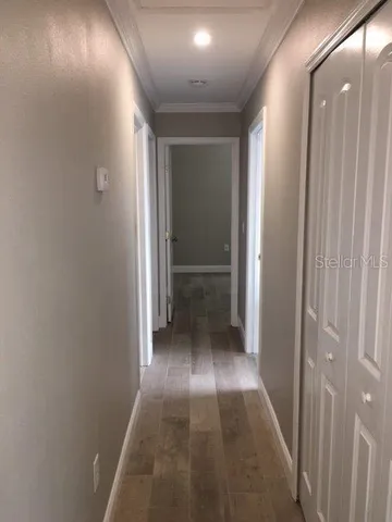 a view of hallway with wooden floor
