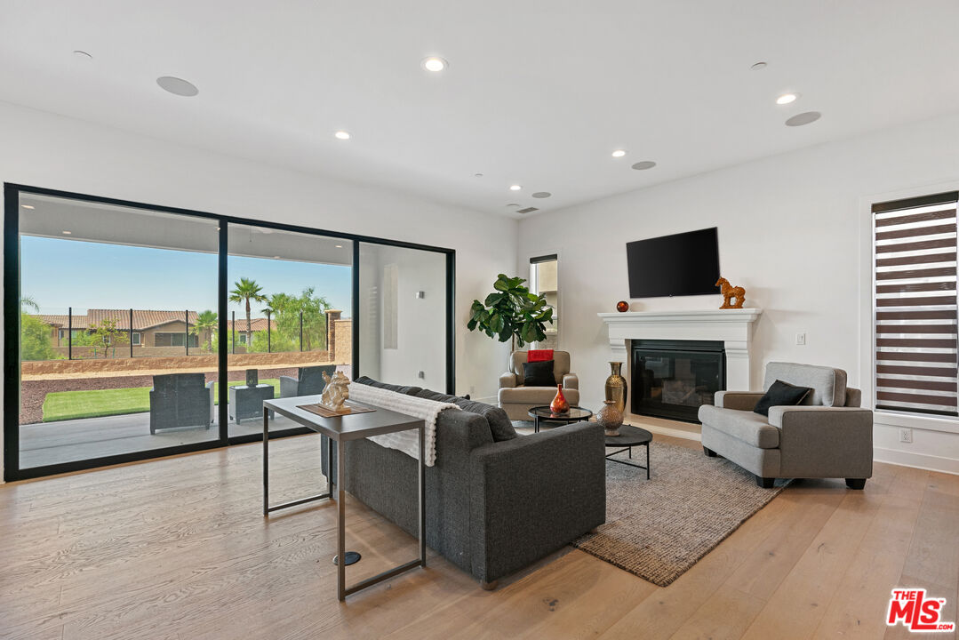 20618 West Wood Rose Court Porter Ranch, CA 91326 - Photo 11 of 44 a living room with furniture a fireplace and a flat screen tv