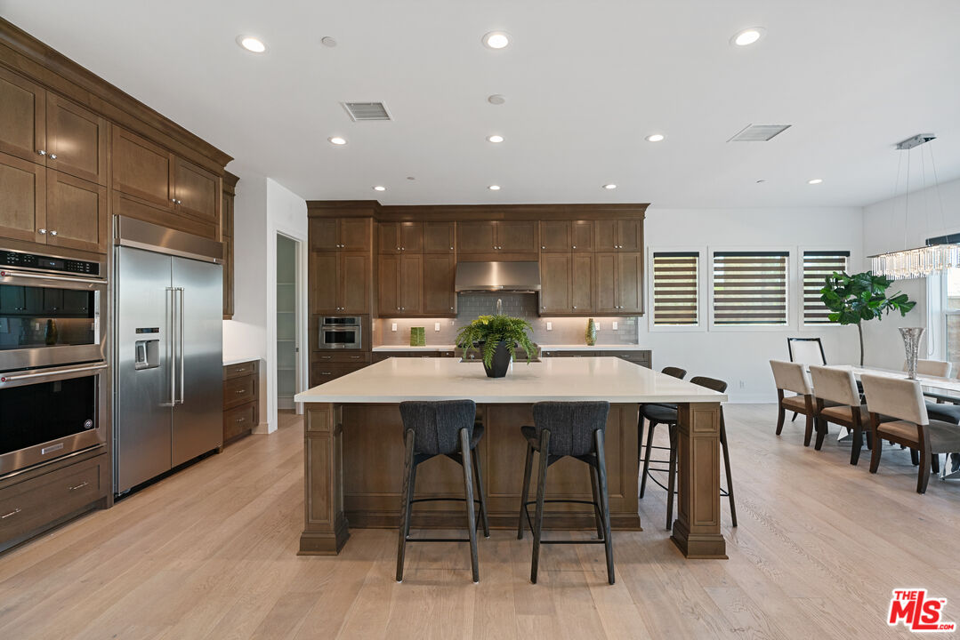 20618 West Wood Rose Court Porter Ranch, CA 91326 - Photo 14 of 44 a view of a dining room with furniture window and wooden floor