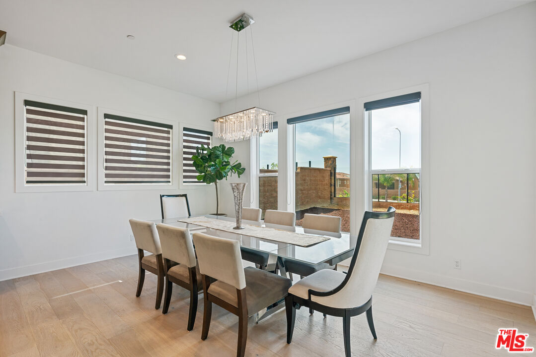 20618 West Wood Rose Court Porter Ranch, CA 91326 - Photo 16 of 44 a view of a dining room with furniture window and outside view