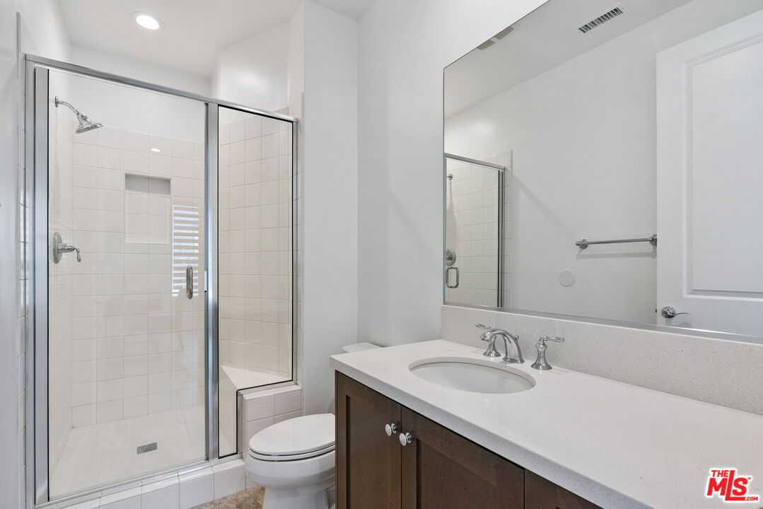 20618 West Wood Rose Court Porter Ranch, CA 91326 - Photo 18 of 44 a bathroom with a granite countertop sink toilet and shower