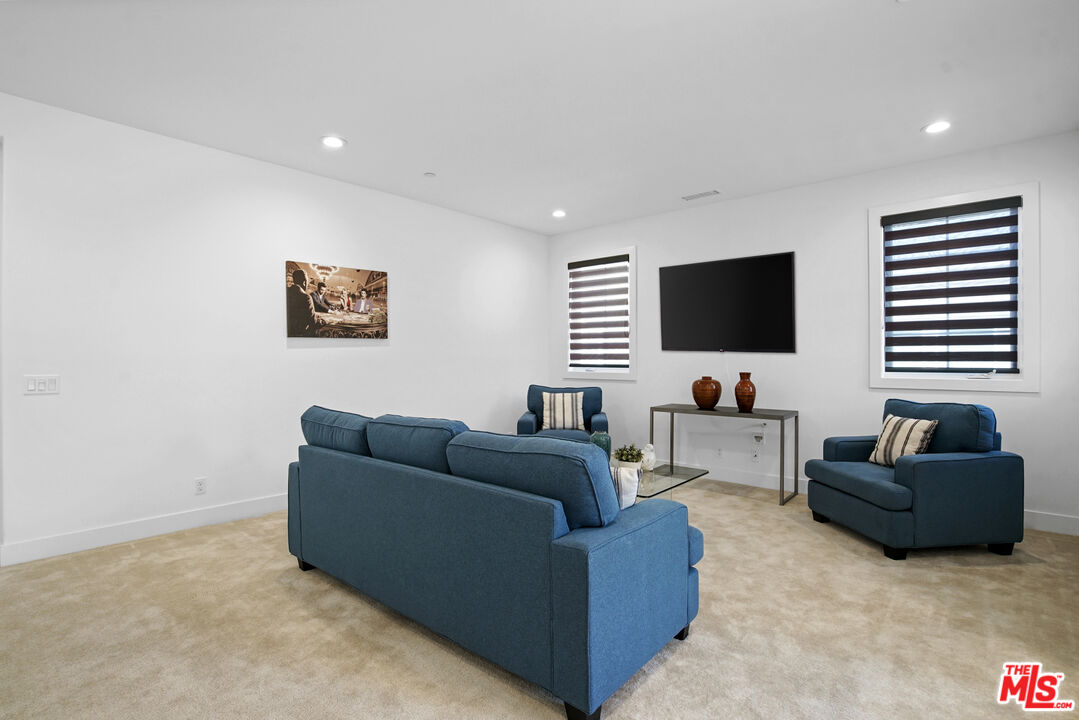 20618 West Wood Rose Court Porter Ranch, CA 91326 - Photo 21 of 44 a living room with furniture and a flat screen tv