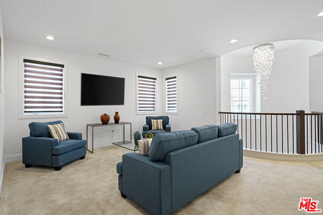 20618 West Wood Rose Court Porter Ranch, CA 91326 - Photo 22 of 44 a living room with furniture and a flat screen tv