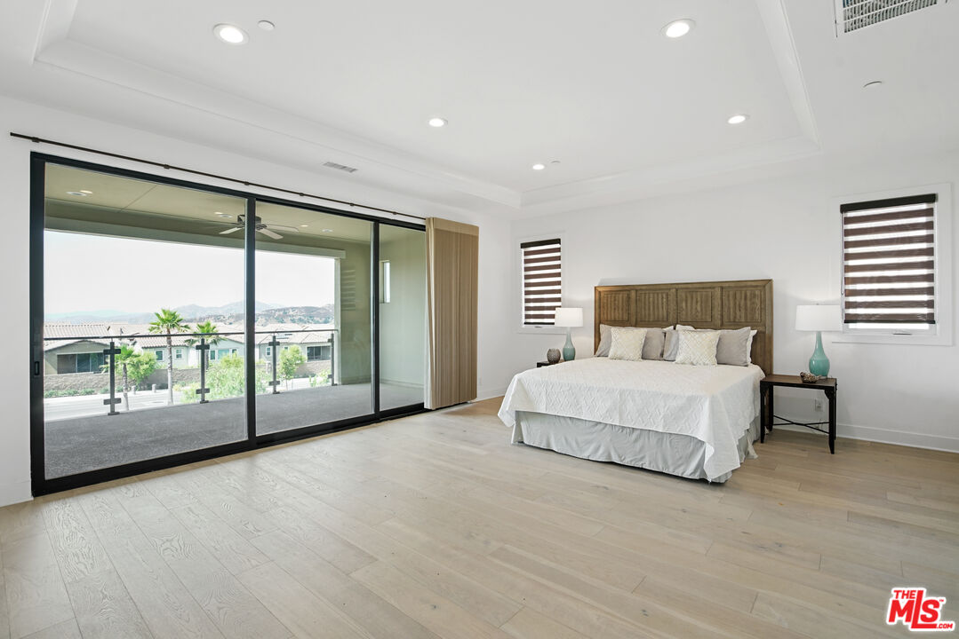 20618 West Wood Rose Court Porter Ranch, CA 91326 - Photo 23 of 44 a spacious bedroom with a large bed and a large window