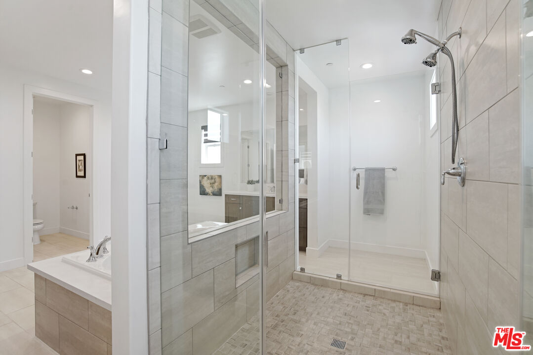 20618 West Wood Rose Court Porter Ranch, CA 91326 - Photo 29 of 44 a bathroom with a shower and a sink