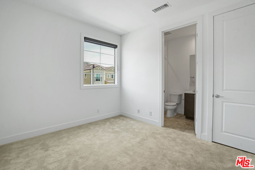 20618 West Wood Rose Court Porter Ranch, CA 91326 - Photo 33 of 44 an empty room with windows and closet