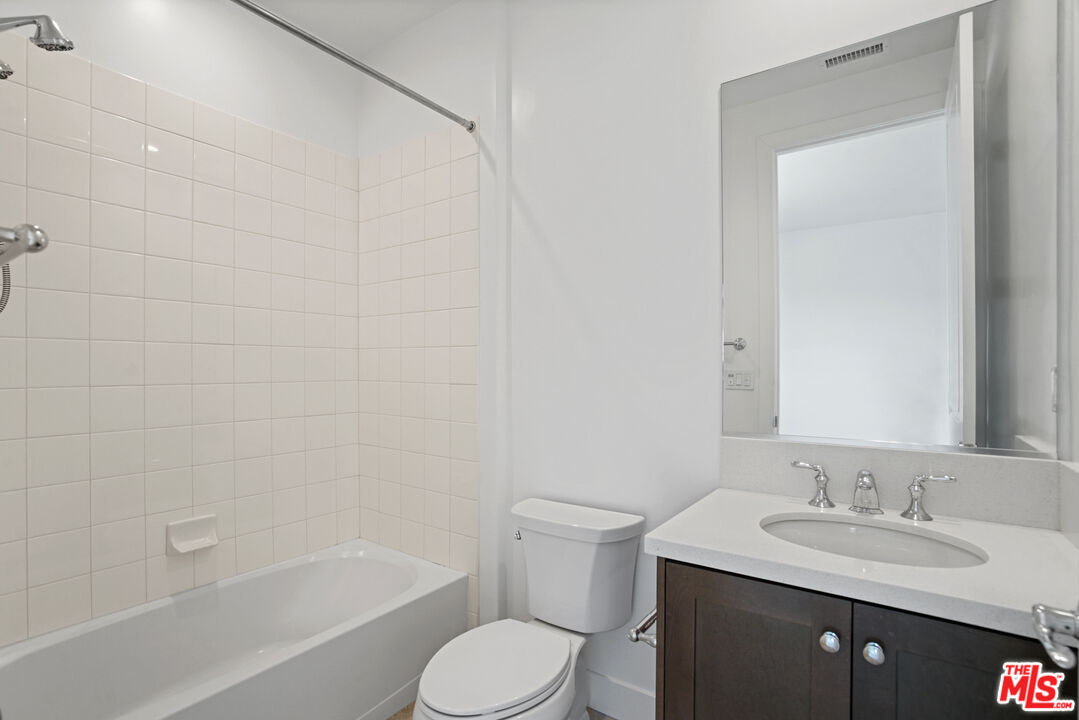 20618 West Wood Rose Court Porter Ranch, CA 91326 - Photo 34 of 44 a bathroom with a bathtub sink vanity mirror and toilet