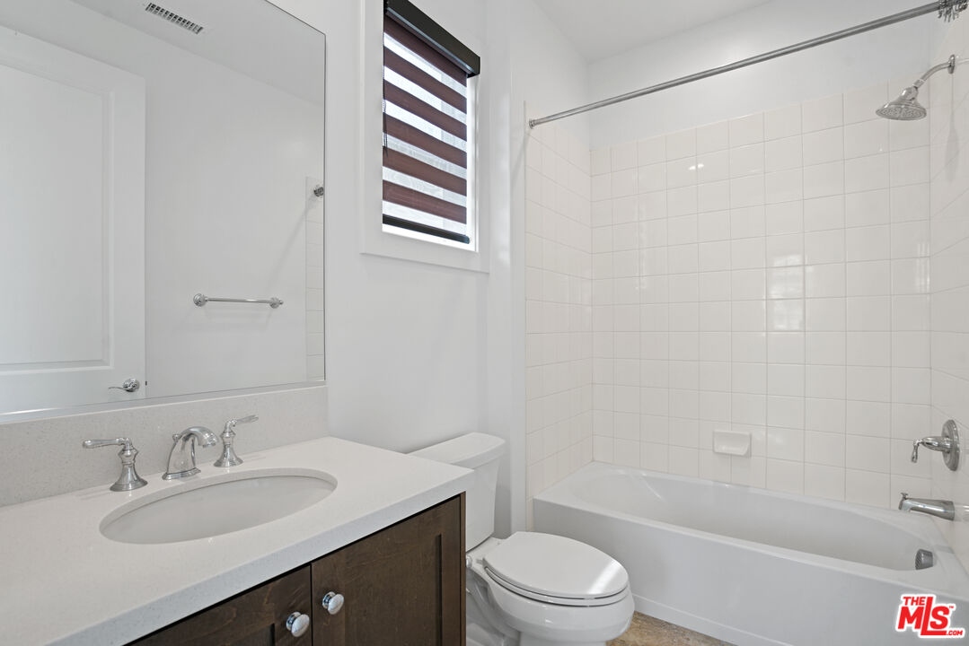 20618 West Wood Rose Court Porter Ranch, CA 91326 - Photo 39 of 44 a bathroom with a sink a toilet and shower
