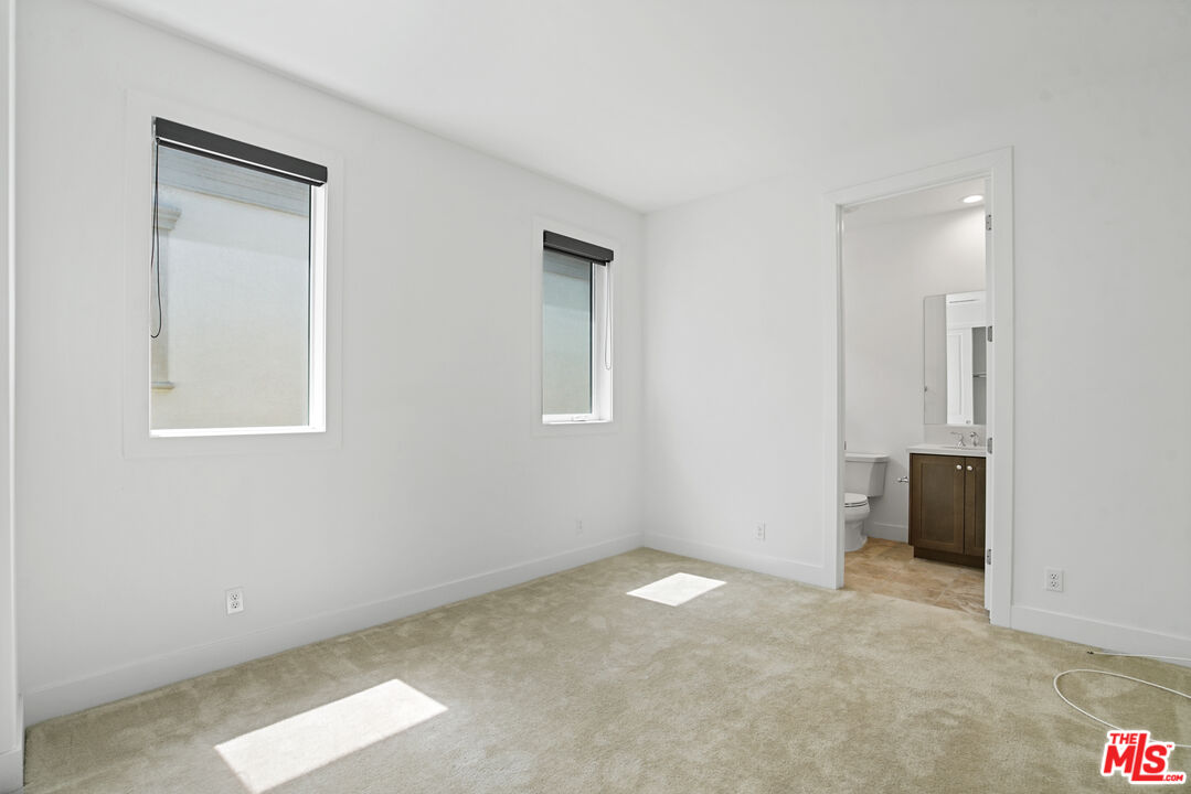 20618 West Wood Rose Court Porter Ranch, CA 91326 - Photo 40 of 44 an empty room with windows and closet
