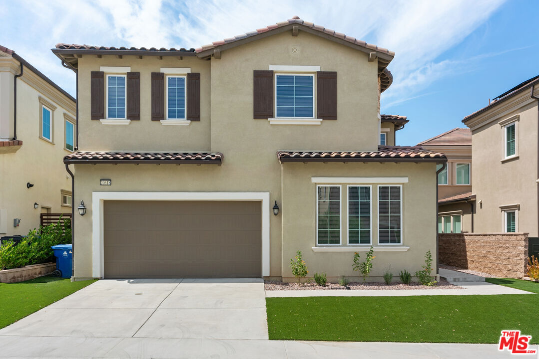 20618 West Wood Rose Court Porter Ranch, CA 91326 - Photo 7 of 44 a front view of a house with a yard